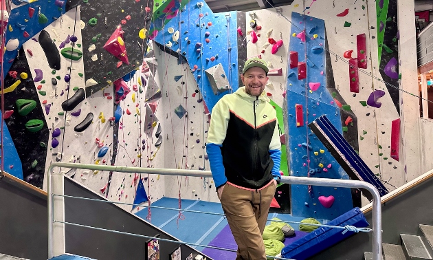 Gord McArthur in front of a climbing wall