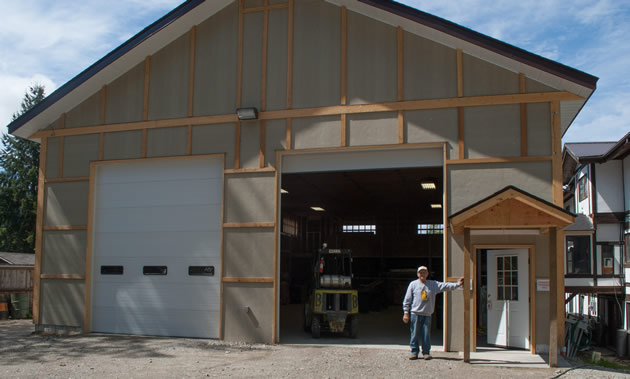A tall gray timber-frame building will be the new lumber yard of Gray Creek Store.