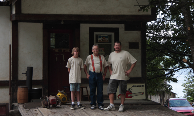 Three generations stand in front of an older building.