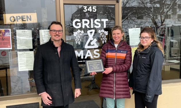 Owners of Grist & Mash Brewery standing outside business. 