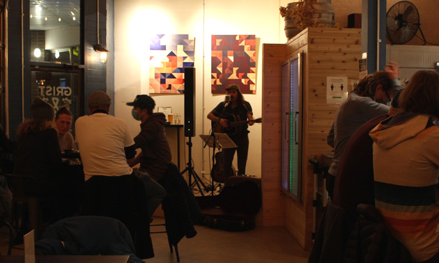 Interior of Grist and Mash, darkened interior, band playing in corner. 