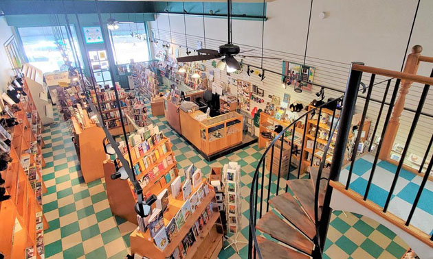 Interior of Grizzly Book & Serendipity Shop, shelves of books, tiled floor. 