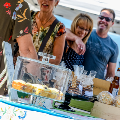 People buying pastries at a farmers market