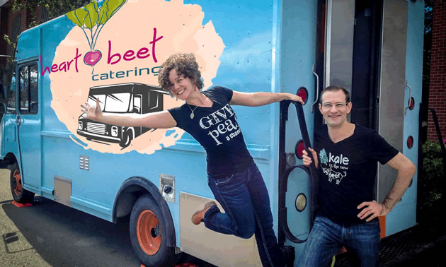 The Heartbeet Catering food truck is a brilliant light blue, with the owners, Michel Kuhn and Nicole Vogt, standing nearby.