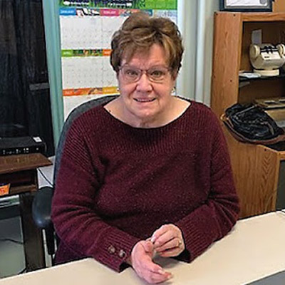 Heather Street sitting at a desk inside the Chamber office. 
