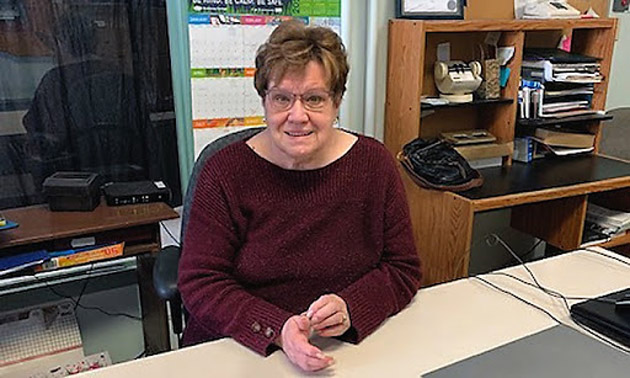 Heather Street sitting at a desk inside the Chamber office. 
