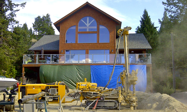 A drill rig sites on-site to install a geothermal energy system.