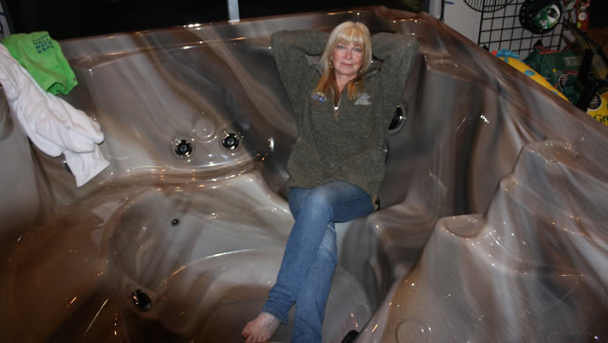 Co-owner Margeaux Bauman of Kootenay Valley Water & Spas in Castlegar sits in one of the many hot tubs the store sells.