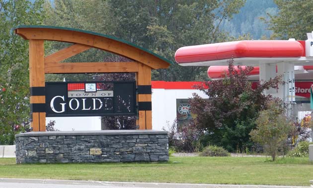 City of Golden sign, with gas station in the background. 