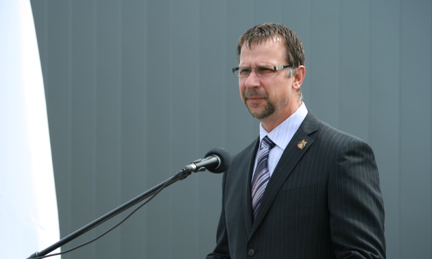 Man in a suit talking into a microphone