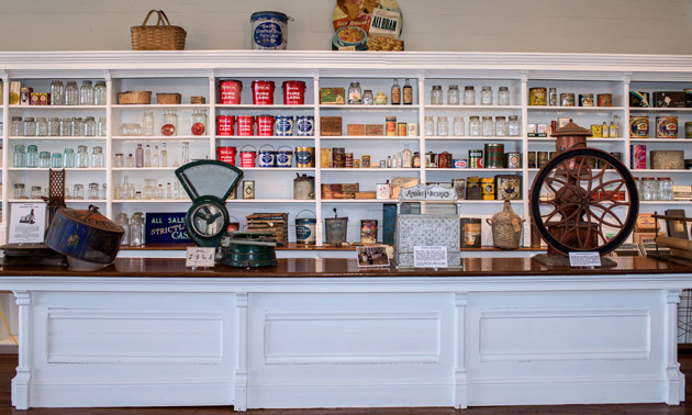 Interior of J.B. Fletcher store showing old-fashioned shelving and antiques.
