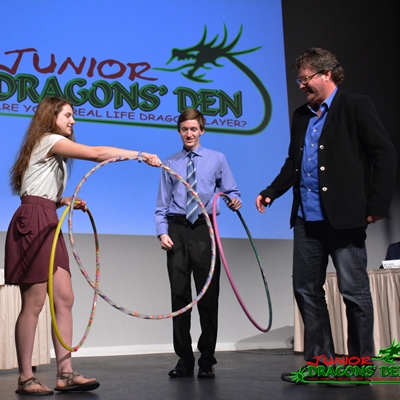 A Junior Dragons Den contestant engages judges Jordan Strobel and Spencer Smith in her demonstration