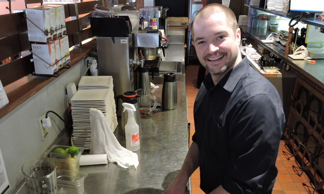 Jordan Perkins, Boston Pizza franchise owner, prepares the restaurant's bar for service in Castlegar, B.C.