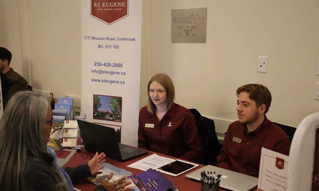 Janice Alpine speaks with staff of the St. Eugene Mission booth at the Ktunaxa Business Showcase. 