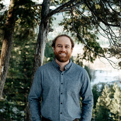Jason Jones of LARCH Landscape Architecture + Authentic Mountain Design in Golden, B.C., and a background of trees.