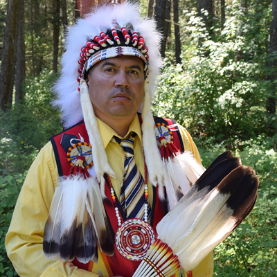 Jason Louie, chief of the Lower Kootenay Indian Band, appears in his ceremonial headdress and colourful beaded vest