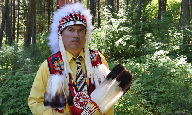 Jason Louie, chief of the Lower Kootenay Indian Band, appears in his ceremonial headdress and colourful beaded vest