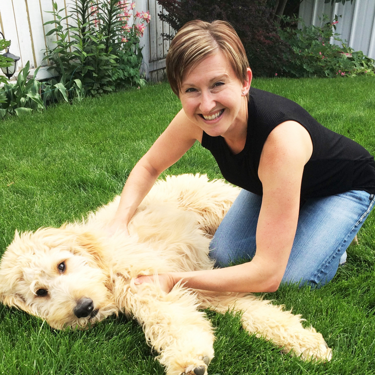 Joanna Sleik playing with Buddy, her adorable golden doodle dog