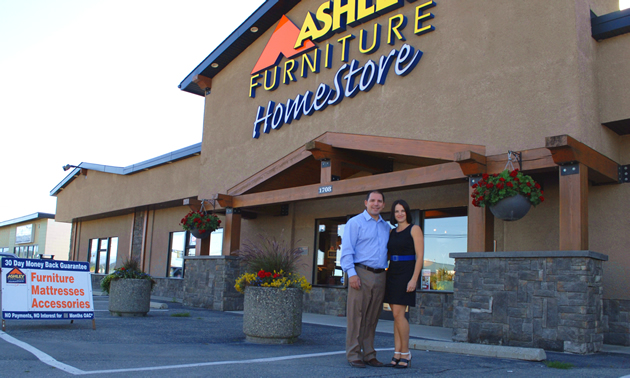 Joey and Christine Hoechsmann stand in front of the Ashley Furniture Homestore in Cranbrook, B.C.