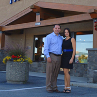 Joey and Christine Hoechsmann stand in front of the Ashley Furniture Homestore in Cranbrook, B.C.