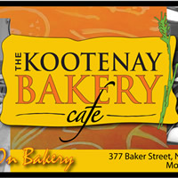Orange and yellow sign with black lettering saying Kootenay Bakery Cafe