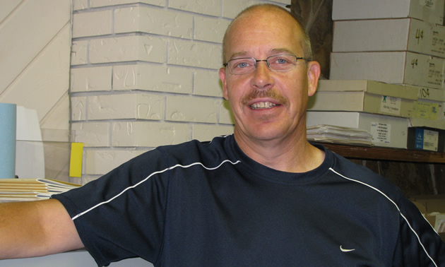 Middle-aged man wearing glasses and a tee-shirt