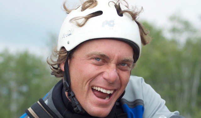Man in a helmet smiling. 