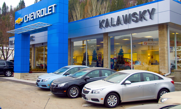 A blue Kalawsky Chevrolet Buick GMC with new vehicles parked in front.