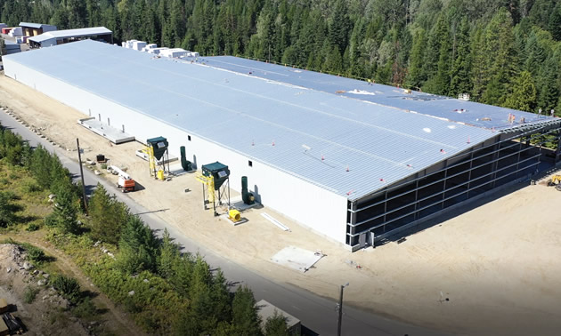 The partially built mass timber is shown, fully enclosed. It will begin partial operations later this year.