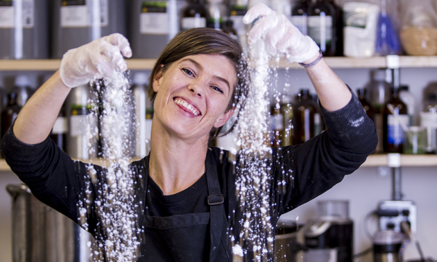 WIth a big smile, Karey Pion is mixing a tub of ingredients.
