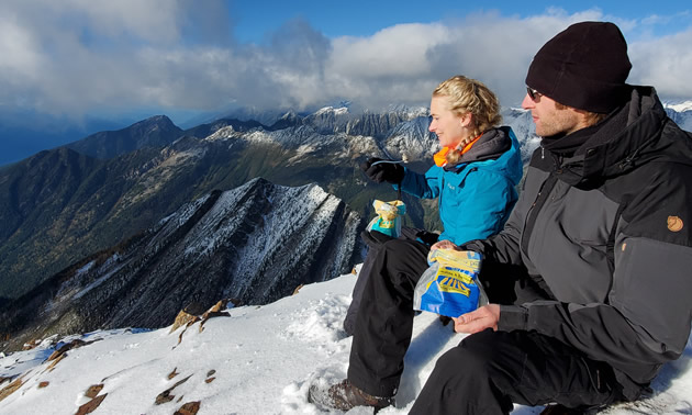 Heidi Lettrari, general manager, and Stefan Lettrari, production manager, of Kaslo Sourdough enjoy a tasty snack while perched on top of a local peak.  
