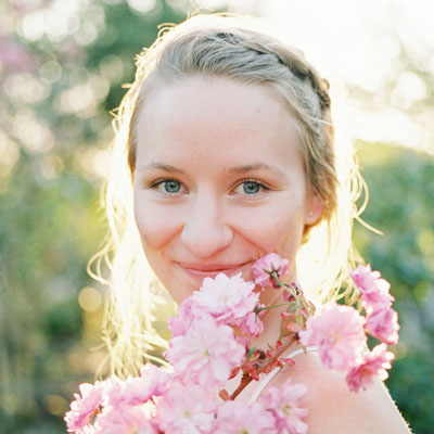 Close up shot of Kathryn Henry holding a bouquet of flowers. 