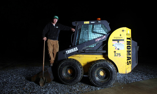 Owner of Kays Contracting, Matt Hanlon, poses with one of his contracting machines.