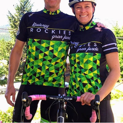 Two bikers wearing custom-designed cycling shirts in green and black. 