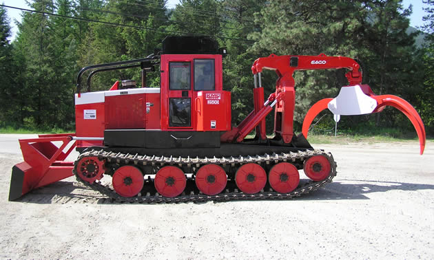 A red tracked machine has pinchers on the front.