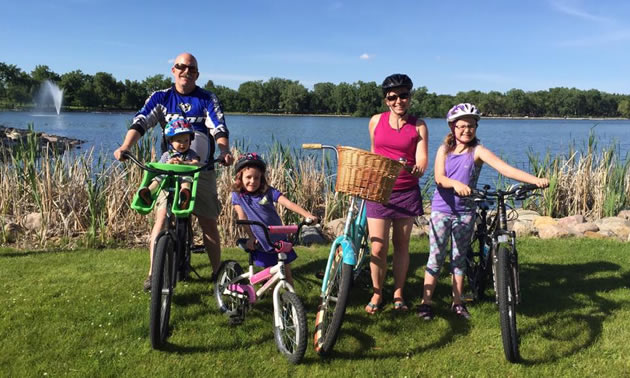 Kristy Jahn-Smith and her family on bikes on sunny day. 