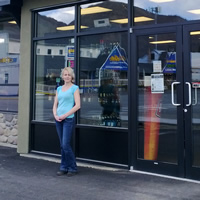 Lori-Ann Dagg stands in front of the doors to Winnipeg Liquor Store in Grand Forks.
