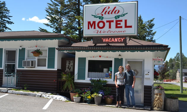 Owners Gabriele and Frank Lorenz are standing in front of the Lido Motel in Radium Hot Springs, B.C.