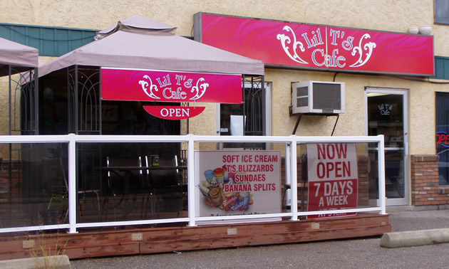 Pink awnings with white lettering shelter the restaurant entry and windows.