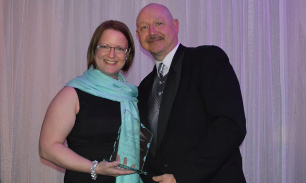 Lisa Barnes holding her Customer Service Excellence award, standing beside Darcy Kennedy