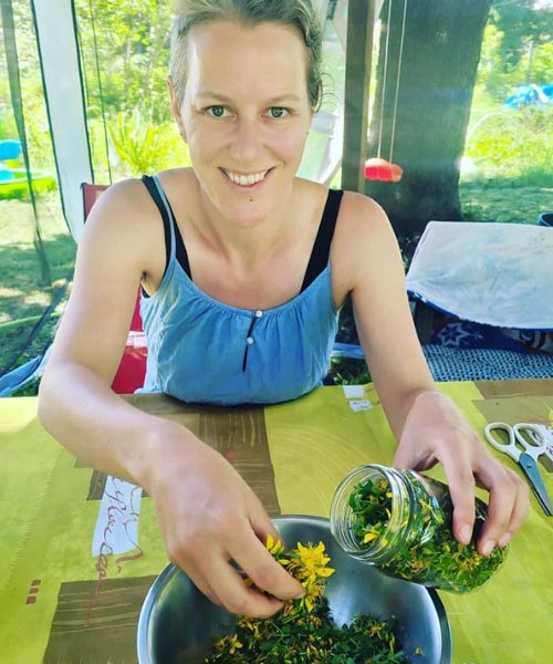 A woman preparing a tincture of St. John's Wort oil. 