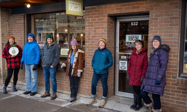 Staff of Local Store standing outside store. 