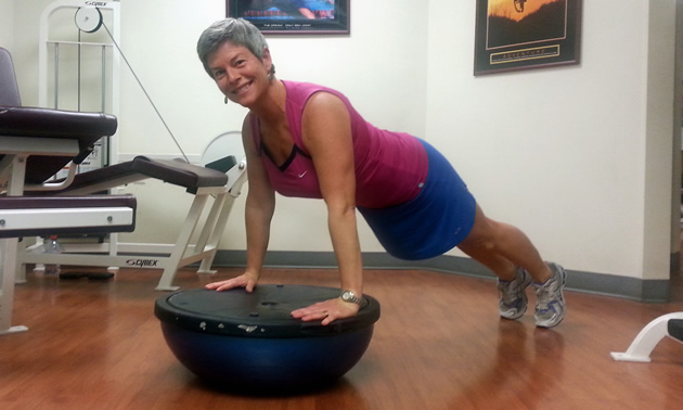 Lori Craig balances on a fitness ball at her business, Better Life Fitness in Rossland.