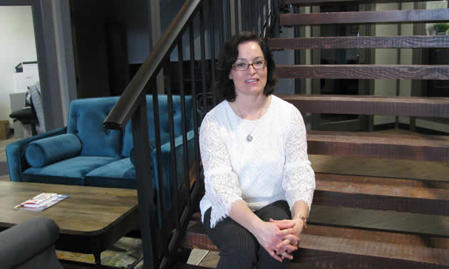 Lynnette Wray sits on the staircase inside the lovely new Ground Floor business complex on Seventh Avenue South in Cranbrook