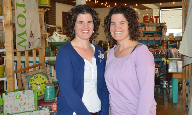 Smiling adult identical twin sisters