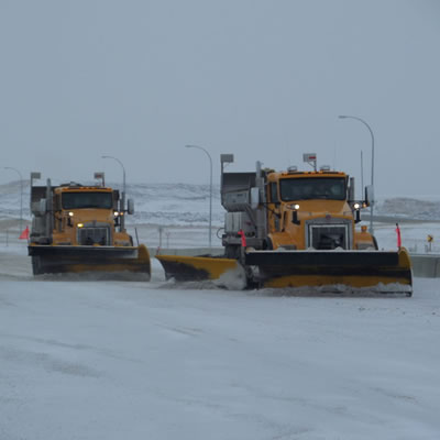 A fleet of Mainroad Contracting's snowplows busy clearing our local highways