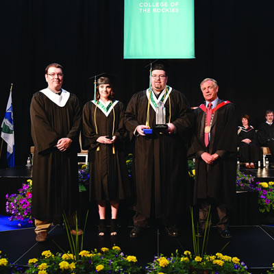(l-r) College of the Rockies’ Board of Governors Chair, Jesse Nicholas, Lieutenant Governor’s Medal recipient, Skyla Gronen, and Governor General’s Bronze Medal and President’s Award of Excellence recipient, Bradley Schmidt joined College President and CEO David Walls at the June 8 Convocation ceremony.