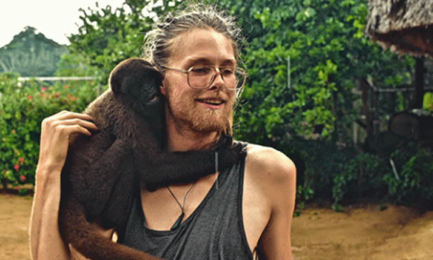 Michael Graeme cuddling a monkey. 