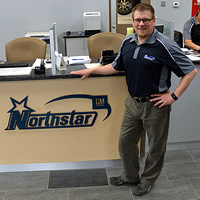 Mike Reid is standing in front of a new desk with the Northstar logo on it.