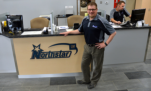 Mike Reid is standing in front of a new desk with the Northstar logo on it.